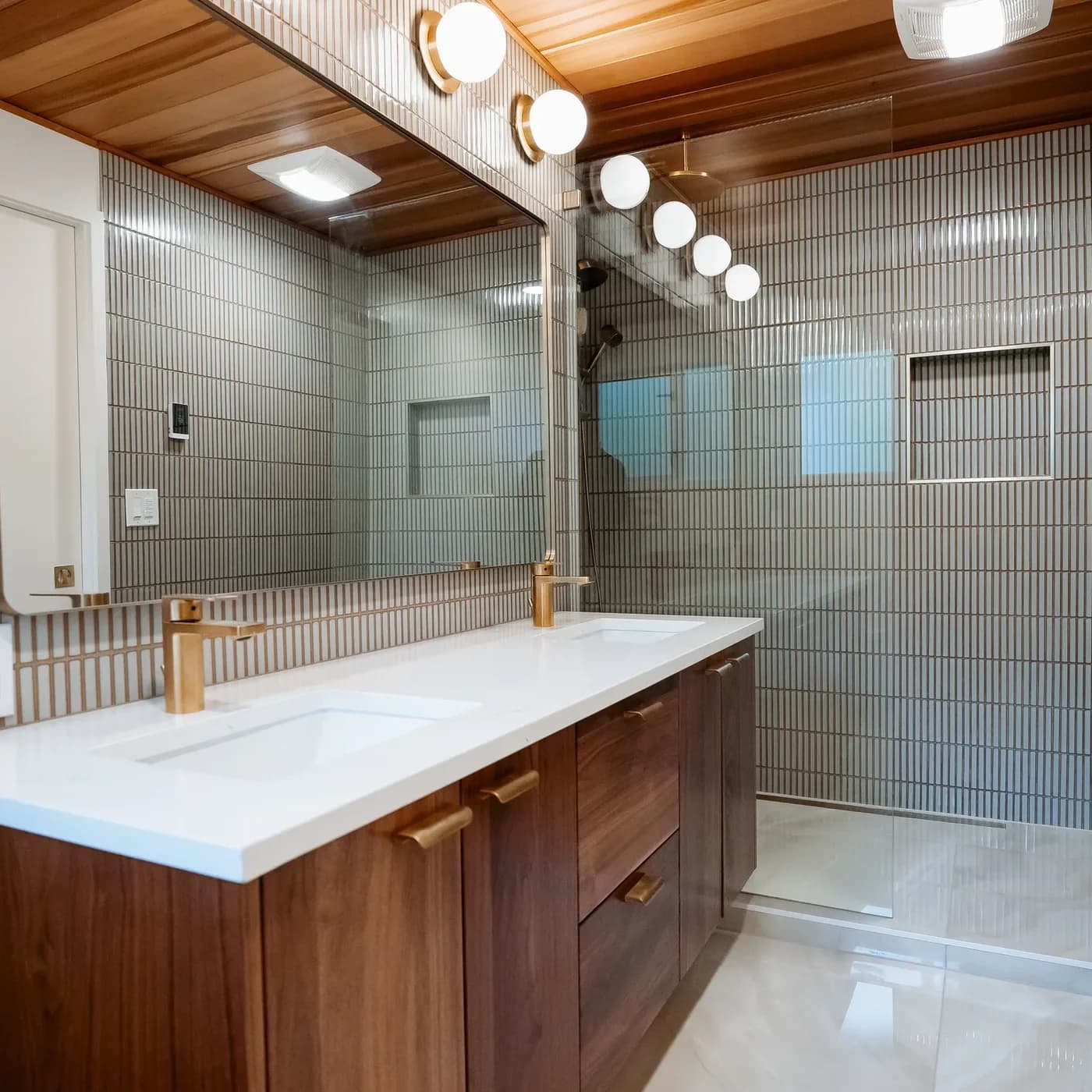 Finished Kirkland master bathroom with cedar ceiling, walnut vanity and kit-kat tile
