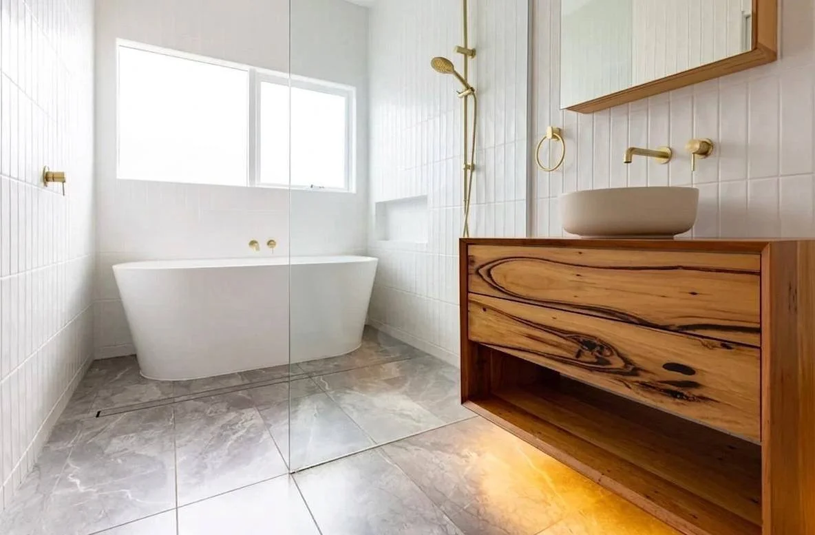 Full bathroom view with freestanding tub, frameless glass shower, recycled timber vanity and brushed brass fixtures — Bellevue WA bathroom remodel