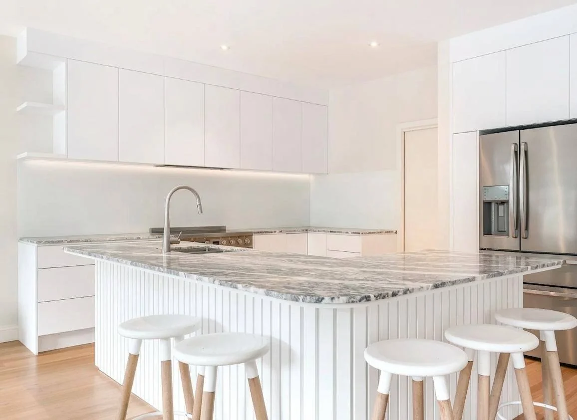 Full kitchen — quartzite island, white cabinets, pro range, oak floors — Bothell WA