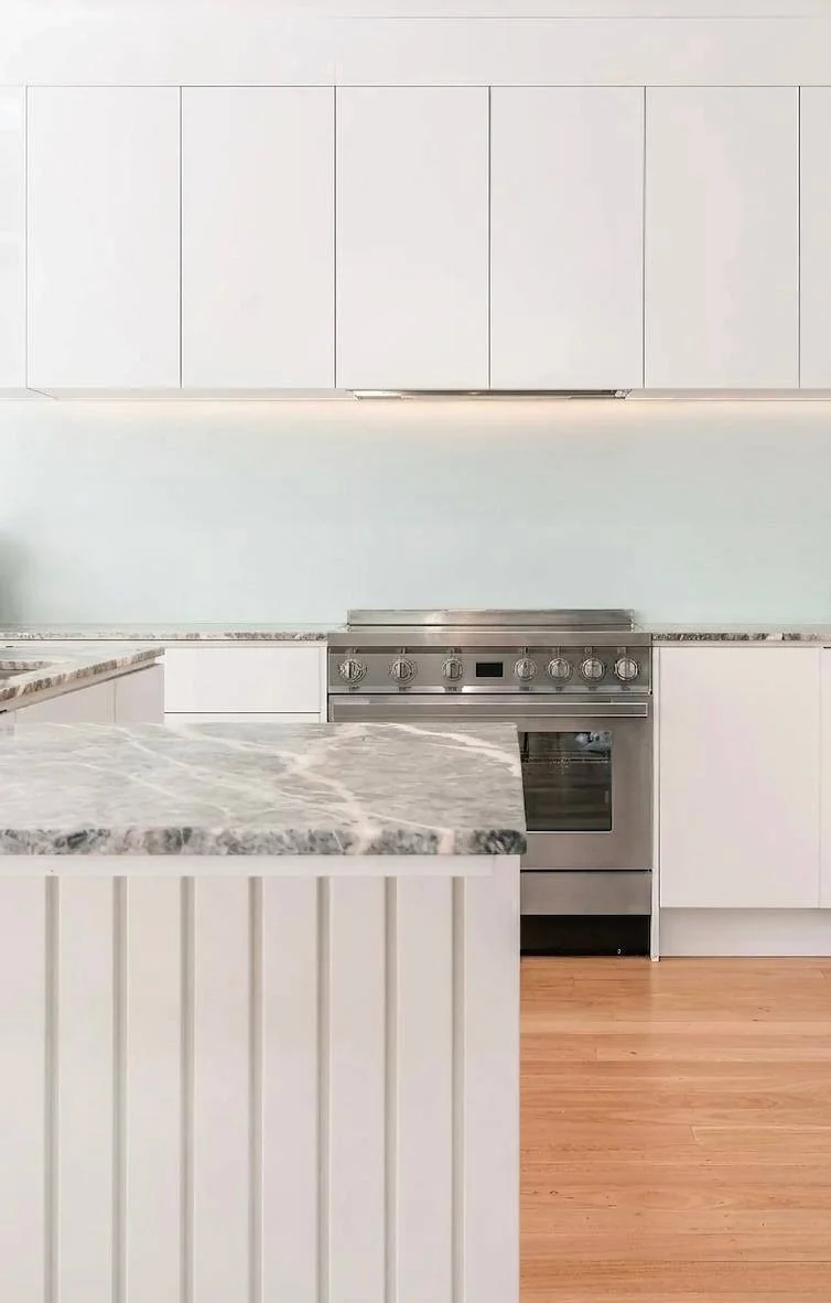 Professional range with quartzite slab backsplash — kitchen renovation Bothell WA
