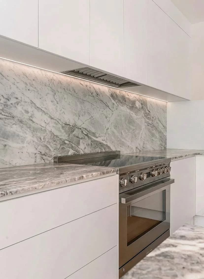 White fluted panel kitchen island with quartzite countertop — Bothell WA