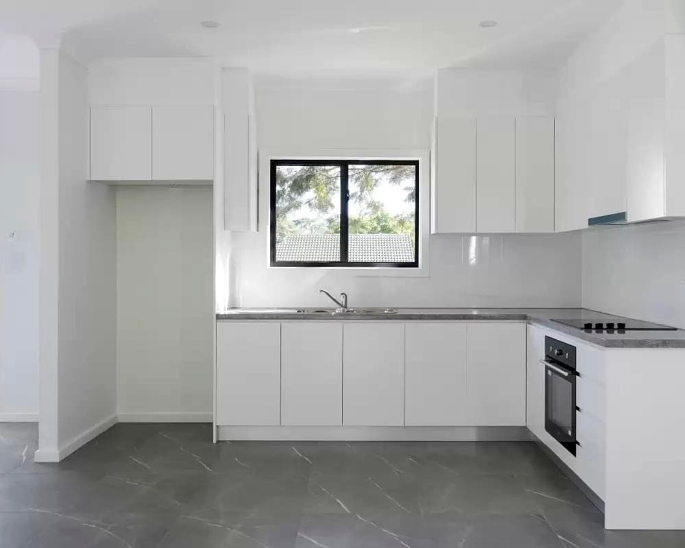 DADU kitchen detail Edmonds — handleless cabinets black frame window built-in oven