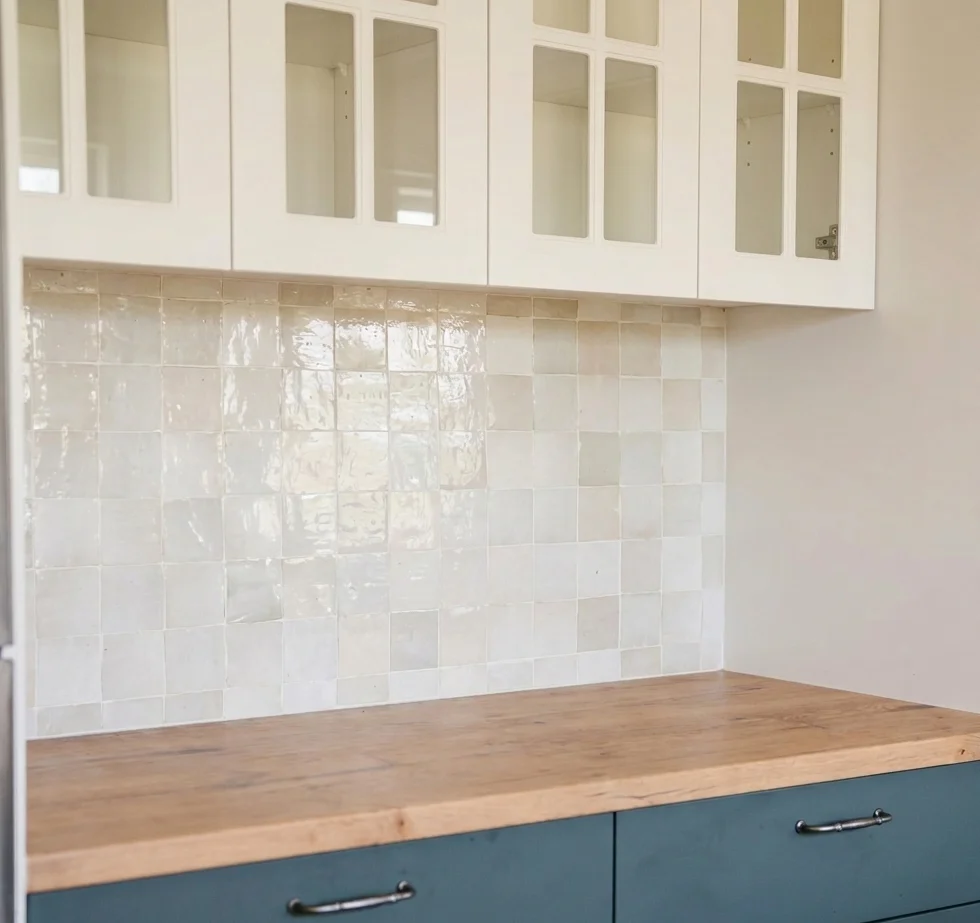 Full L-shaped kitchen view with teal cabinets, stainless fridge, dining table, and hardwood floors — kitchen renovation Edmonds WA