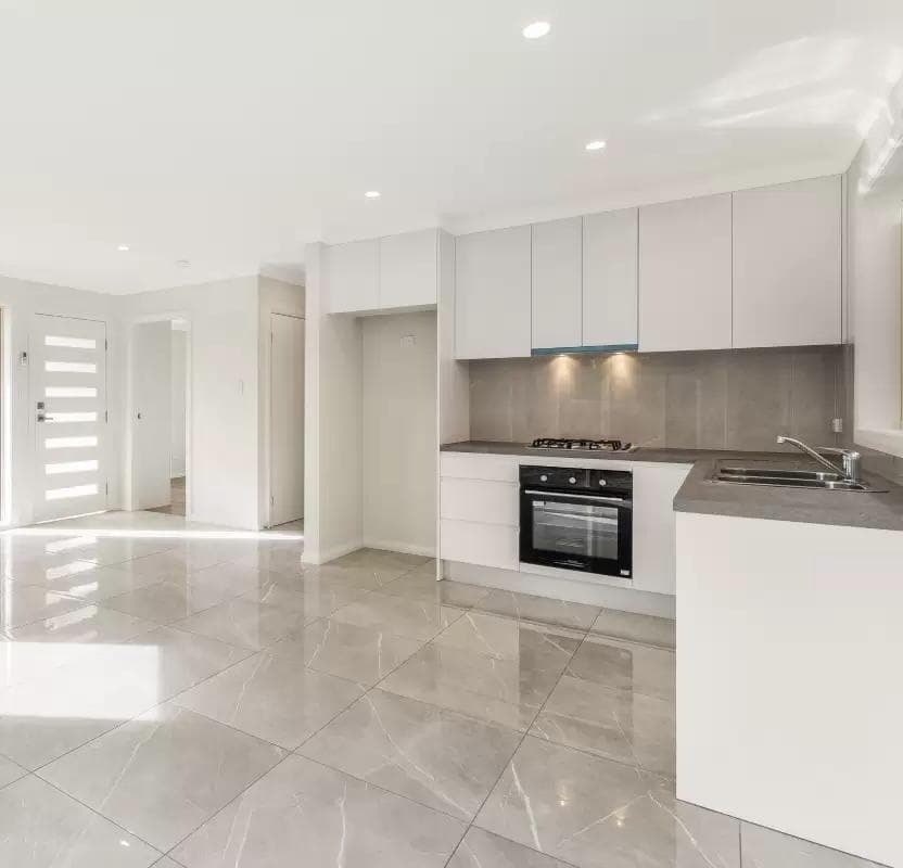 Full kitchen living view attached ADU Kirkland — open plan polished porcelain hallway to bedrooms