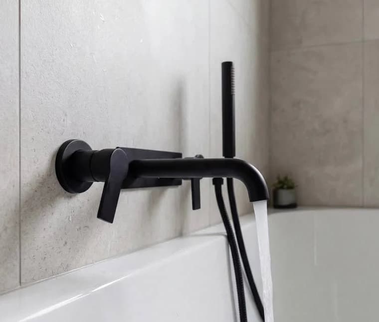 Matte black wall-mounted tub faucet with handheld shower — bathroom remodeling Kirkland WA