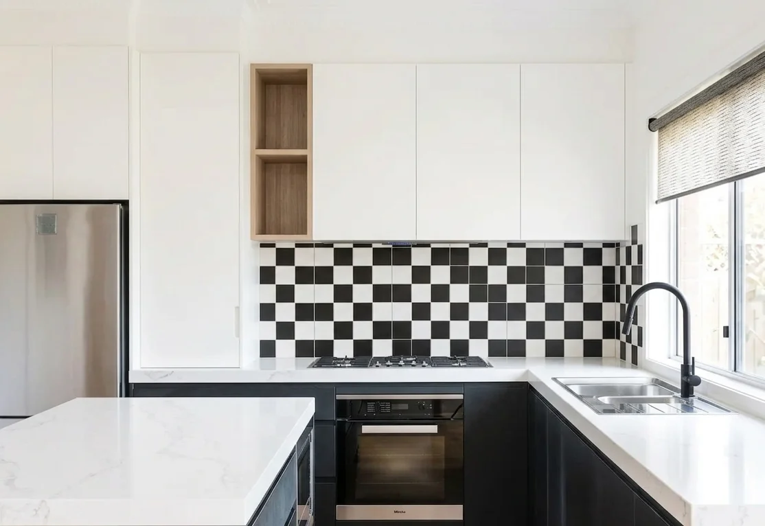 Black and white U-shaped kitchen with zellige backsplash, white quartz peninsula, Miele appliances, and gold pendant — Renton WA kitchen remodel