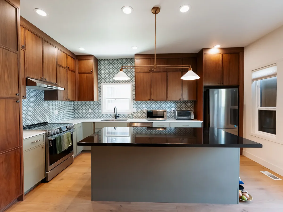 Walnut and sage kitchen with black quartz island and blue penny-round backsplash, Capitol Hill Seattle