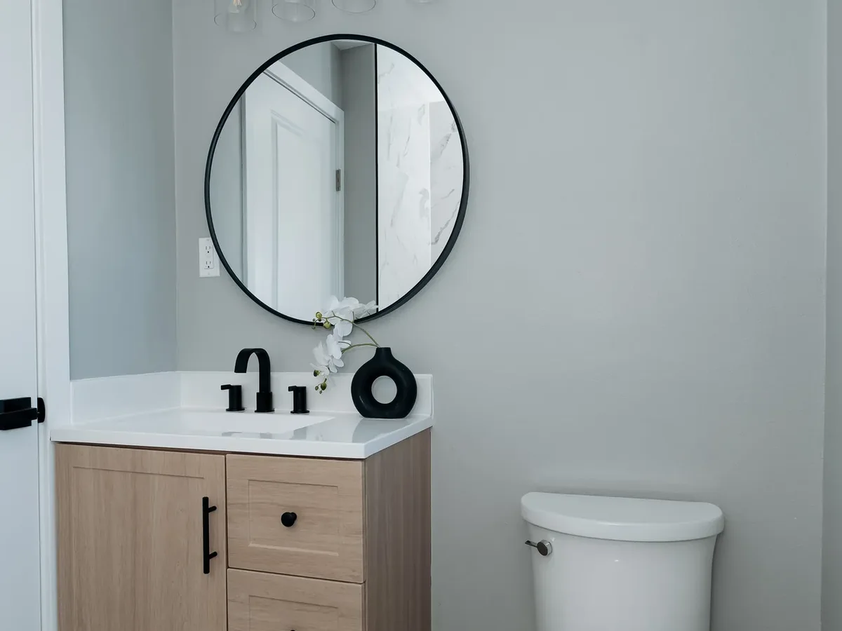 New upstairs bathroom with floating vanity and round black mirror, Sand Point Seattle