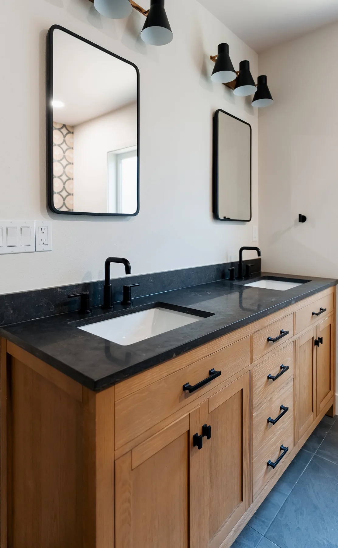 Undermount sink in black quartz with matte-black faucet and mirror, Capitol Hill bathroom