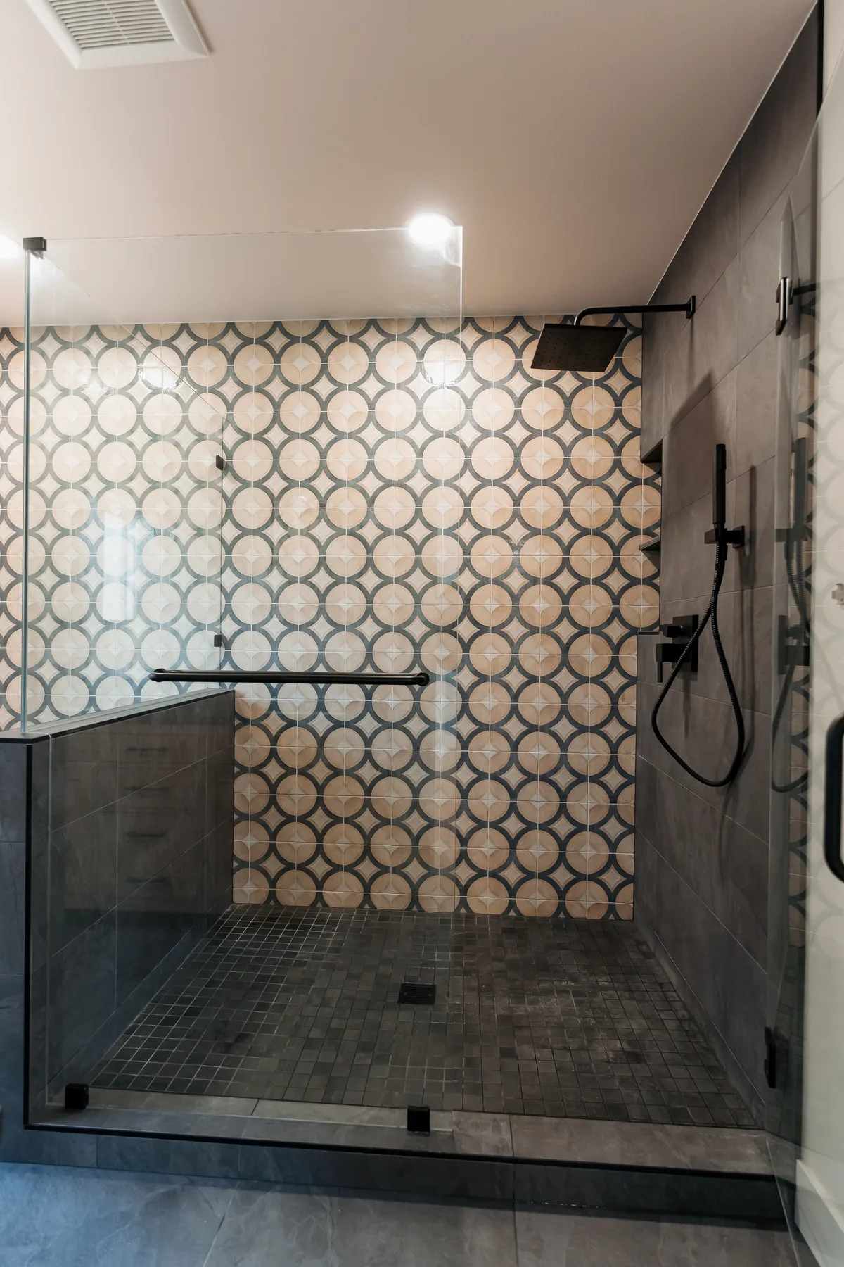 Walk-in shower with patterned porcelain tile, black slate floor and frameless glass, Capitol Hill
