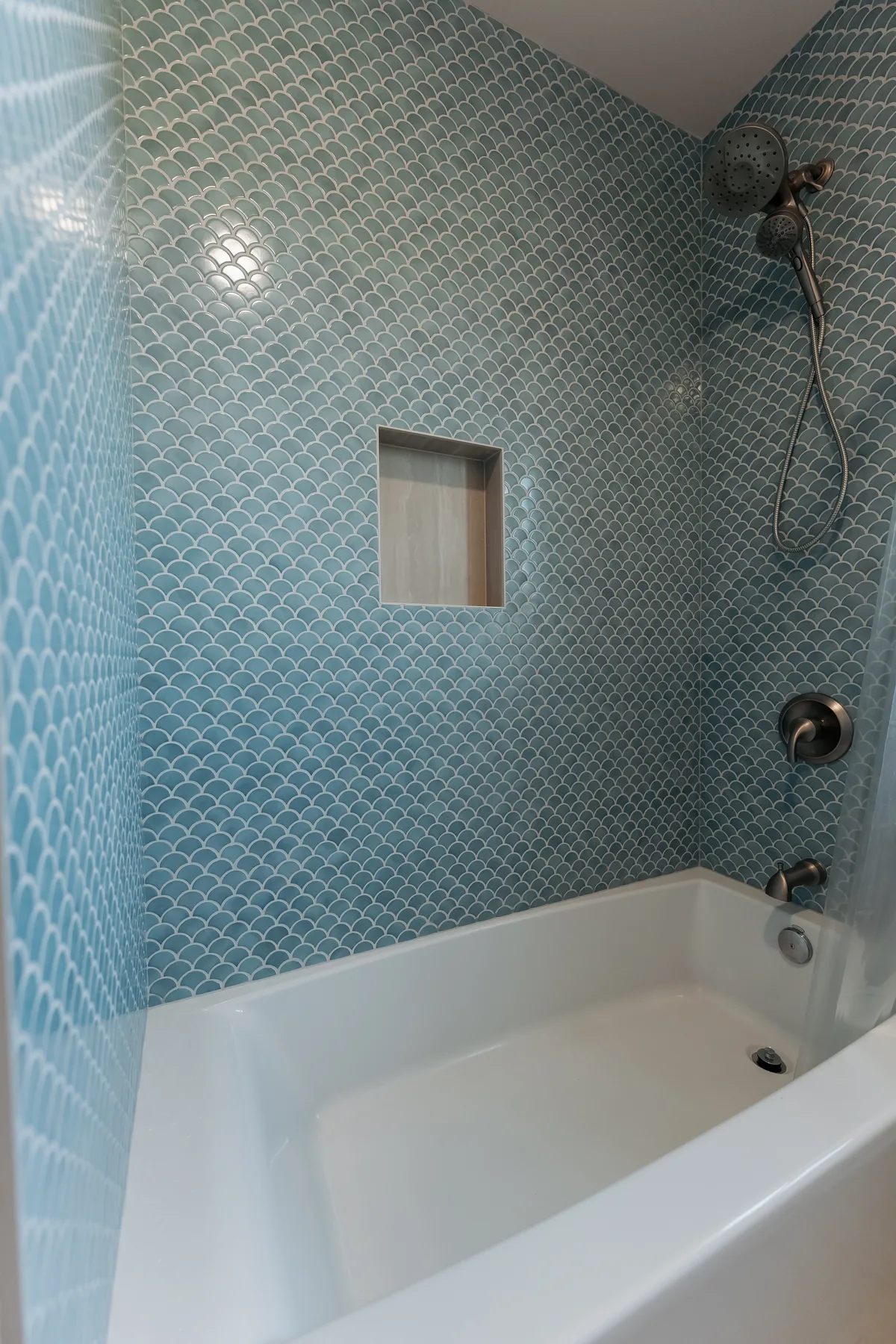 Bathtub with blue fish-scale tile to the ceiling and a recessed niche, Capitol Hill remodel