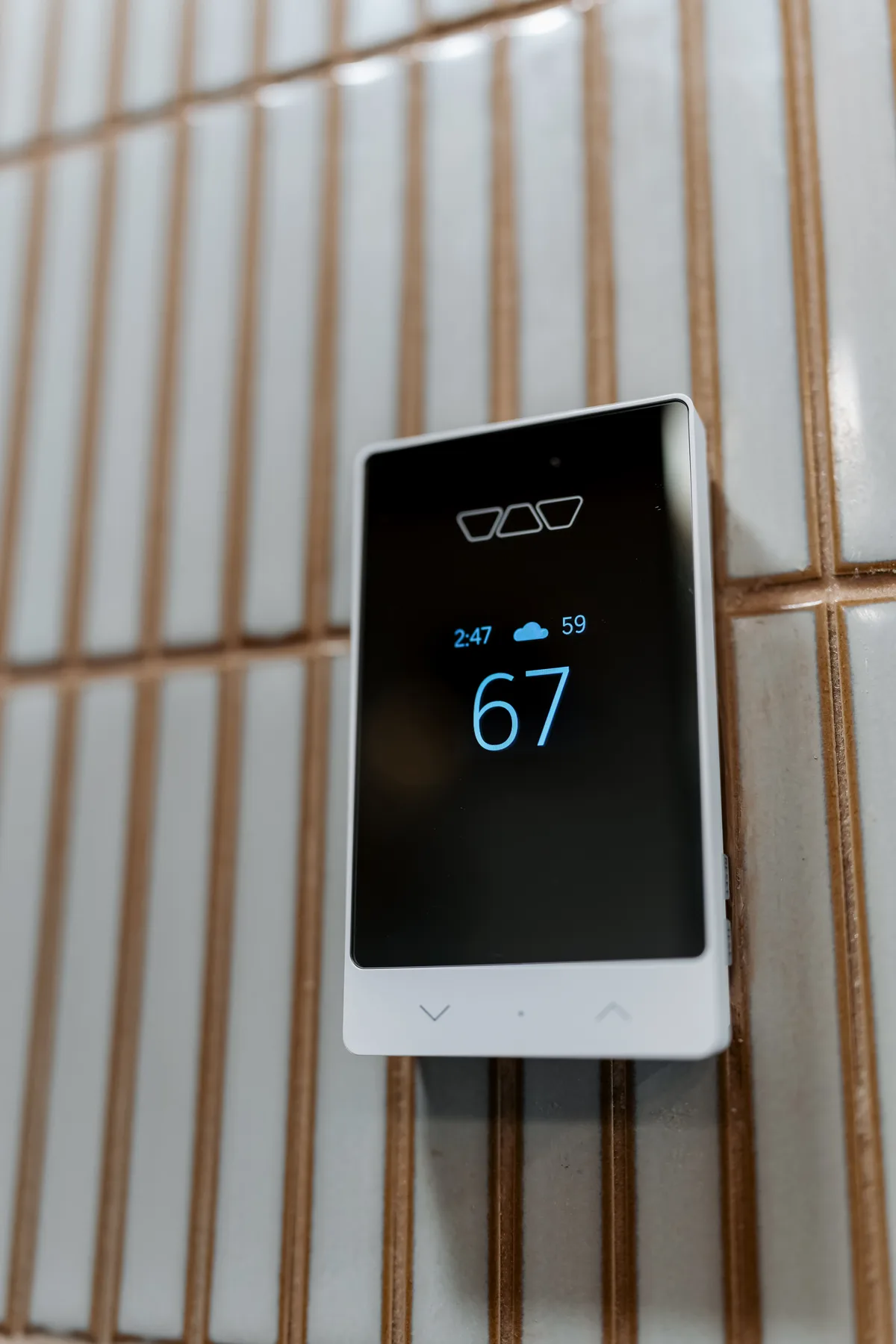 Heated-floor thermostat set into the tiled wall