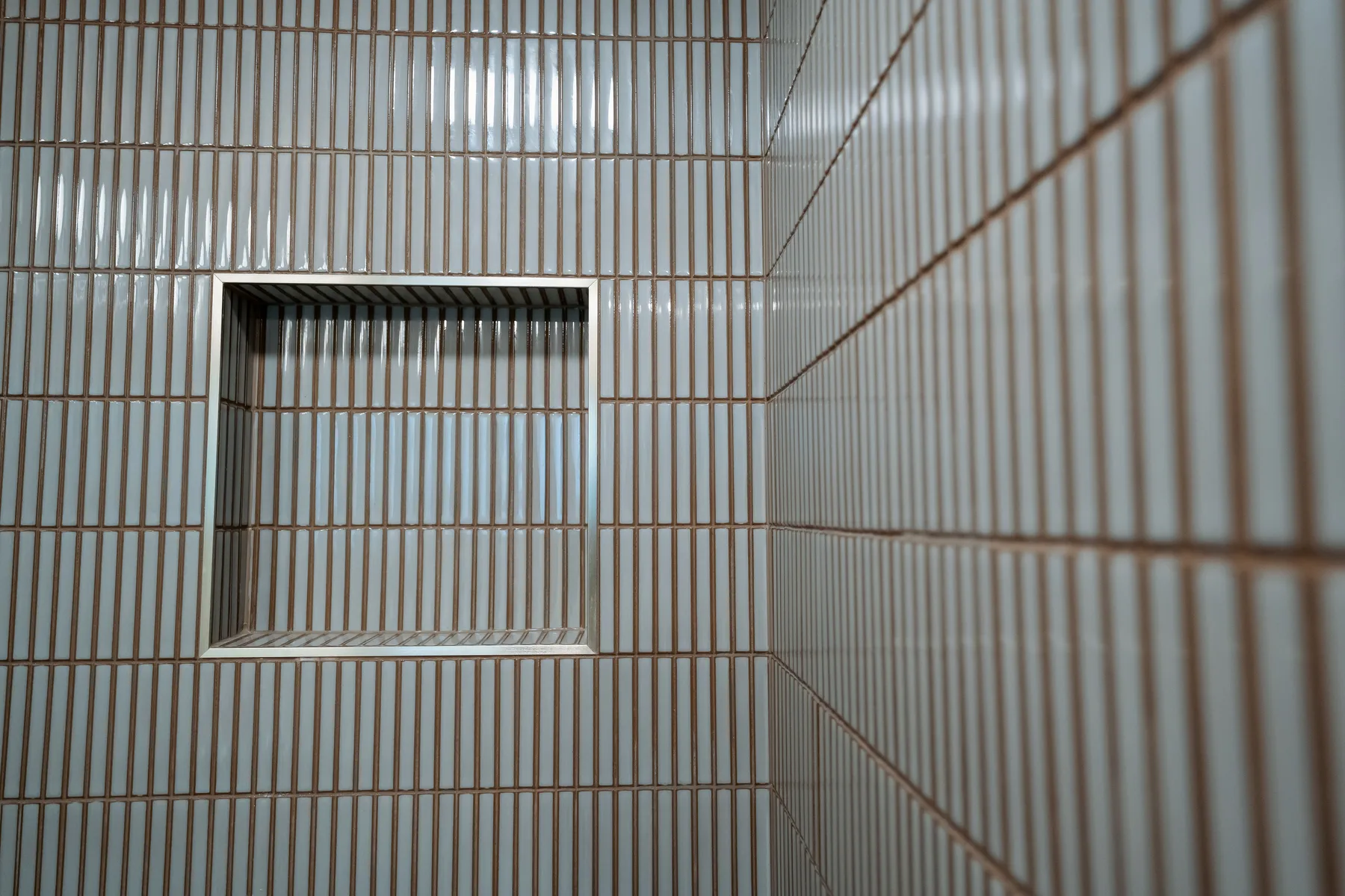 Walk-in shower with white kit-kat tile, warm grout and a recessed niche, Kirkland