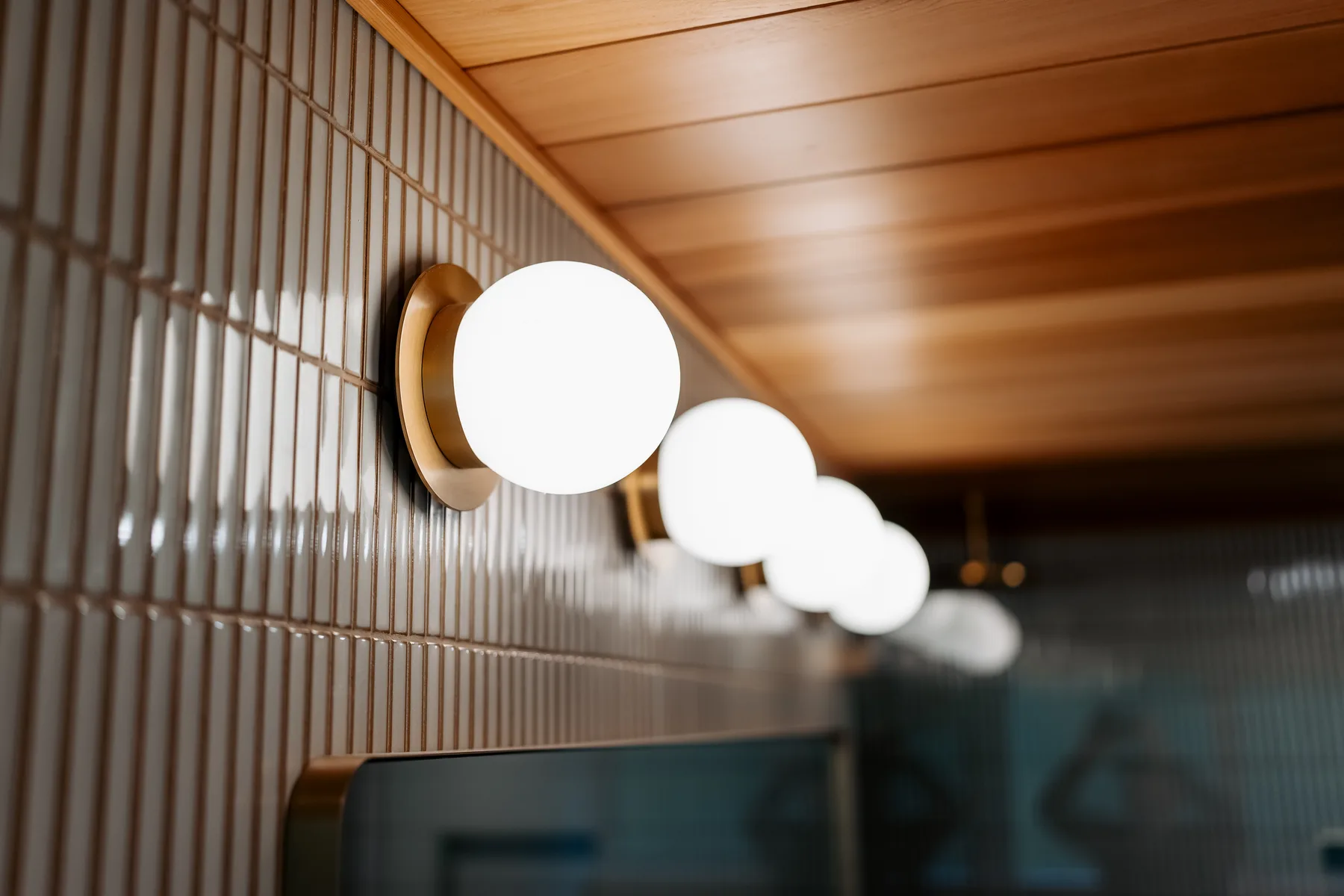 Globe vanity lights against the cedar ceiling