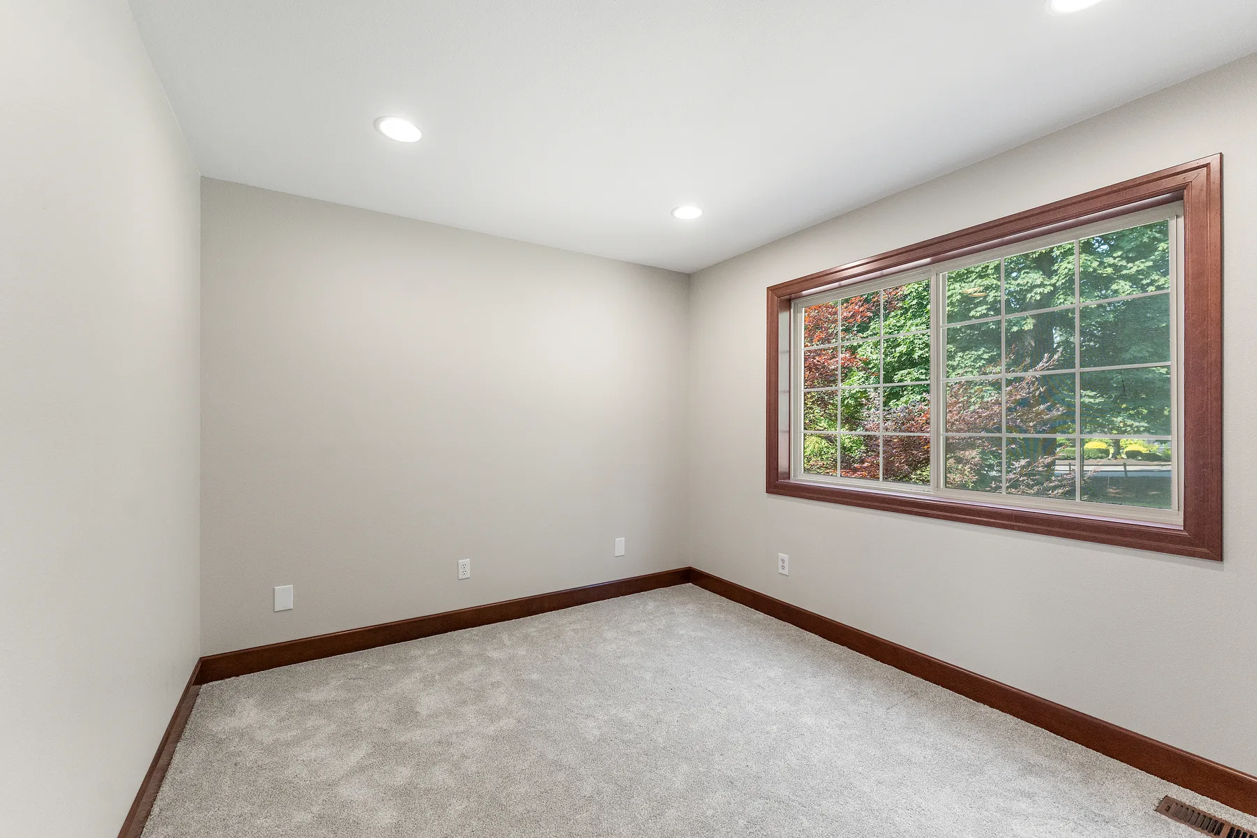 Bedroom with new carpet and recessed lighting in Puyallup, WA