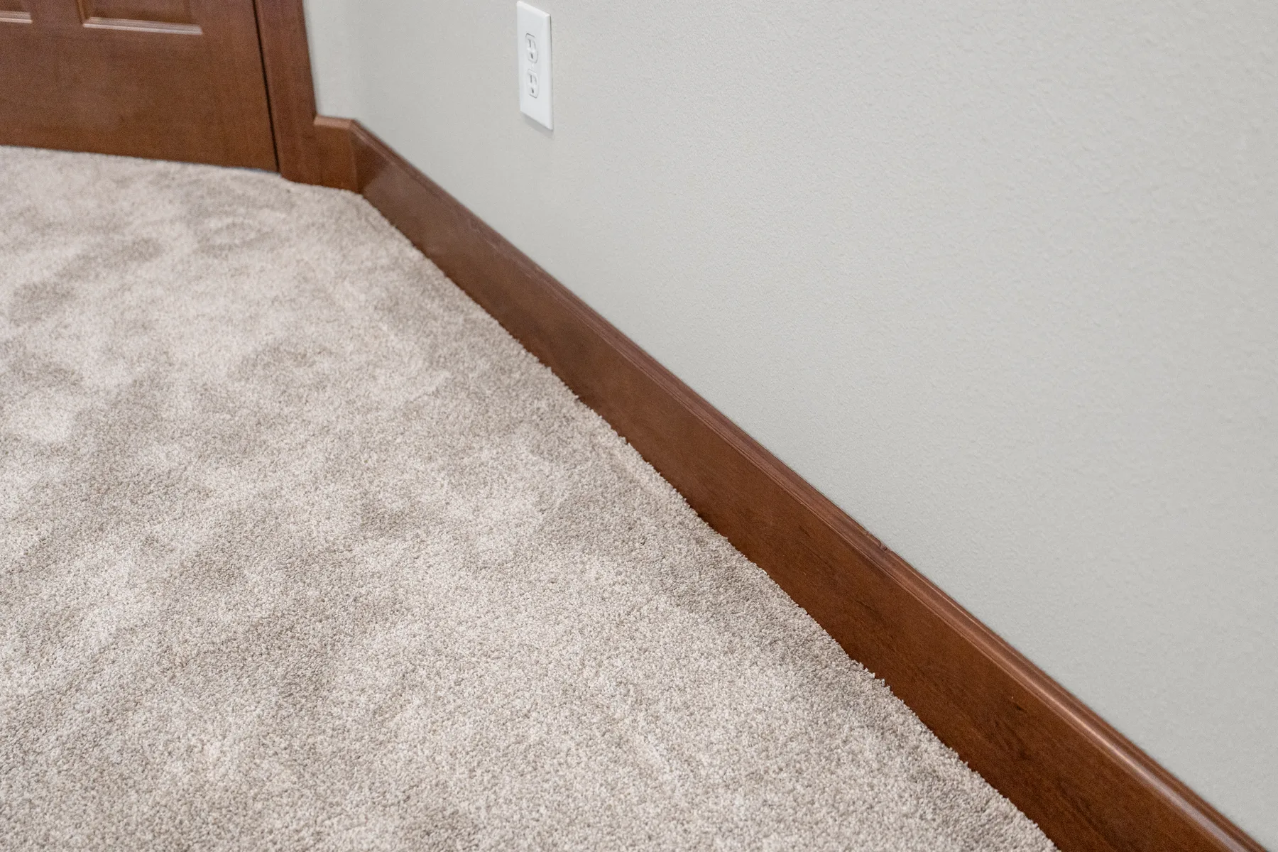 New carpet and solid-wood baseboard detail, Puyallup, WA