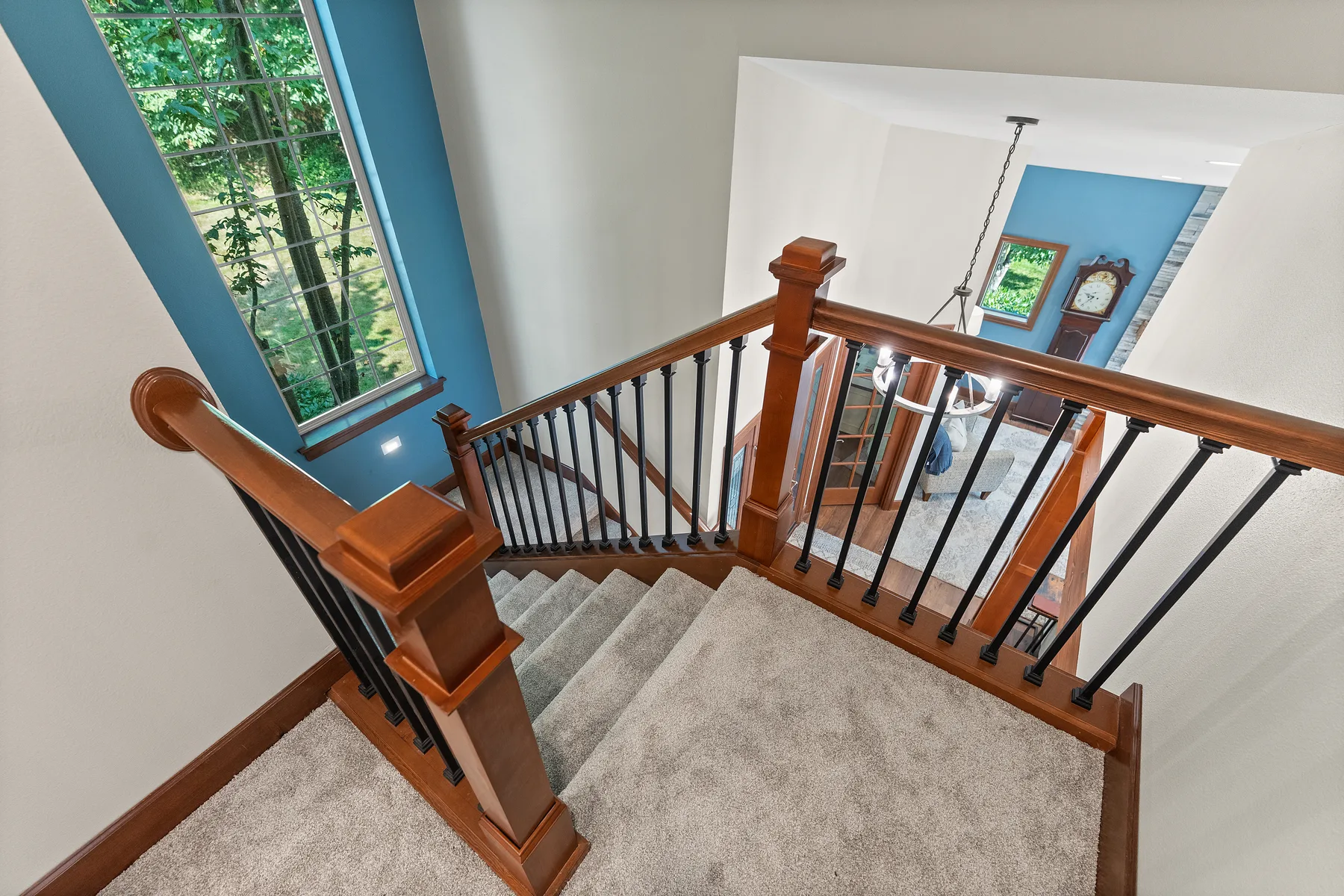 Upper landing with railing and black metal balusters in Puyallup, WA