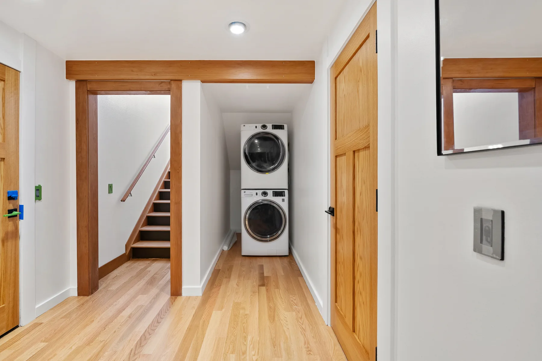 New basement laundry room with stacked washer and dryer, Redmond WA