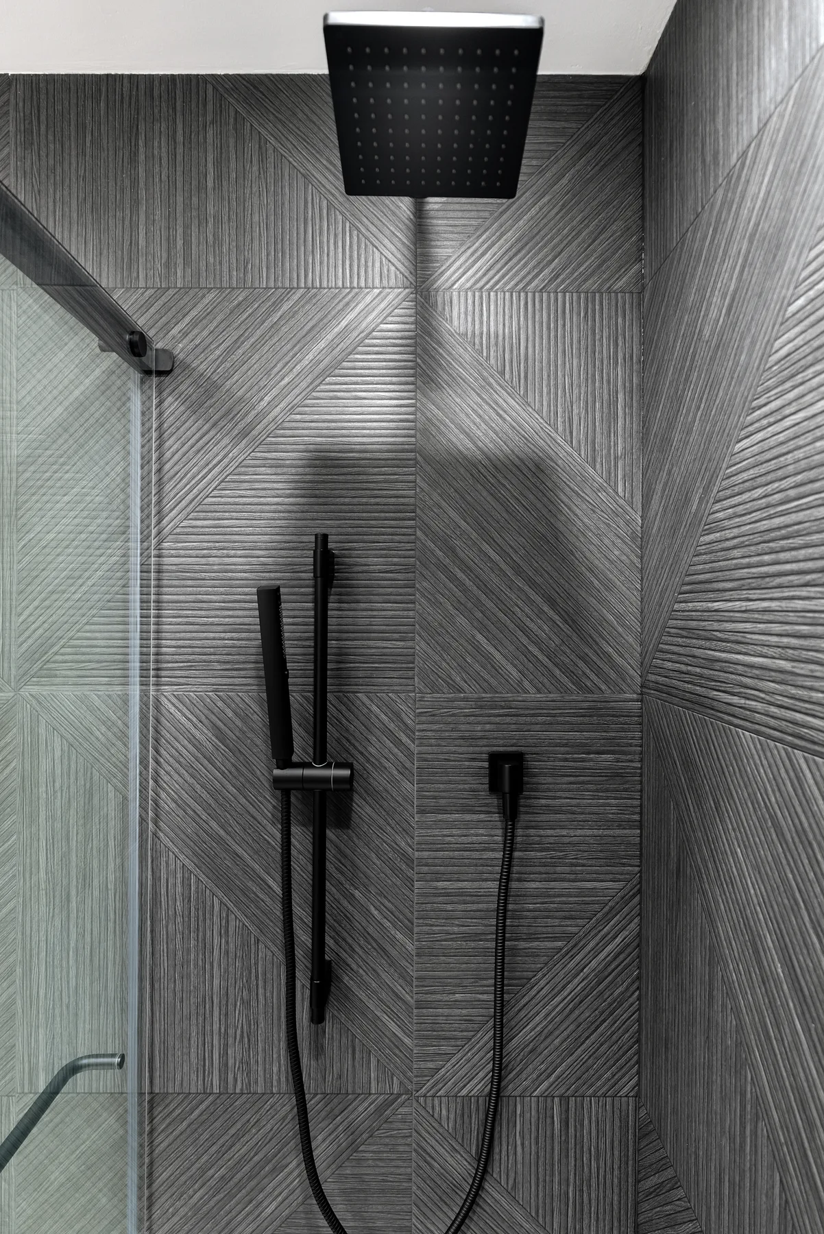 Charcoal feature-tile walk-in shower with matte-black rain head, Redmond WA