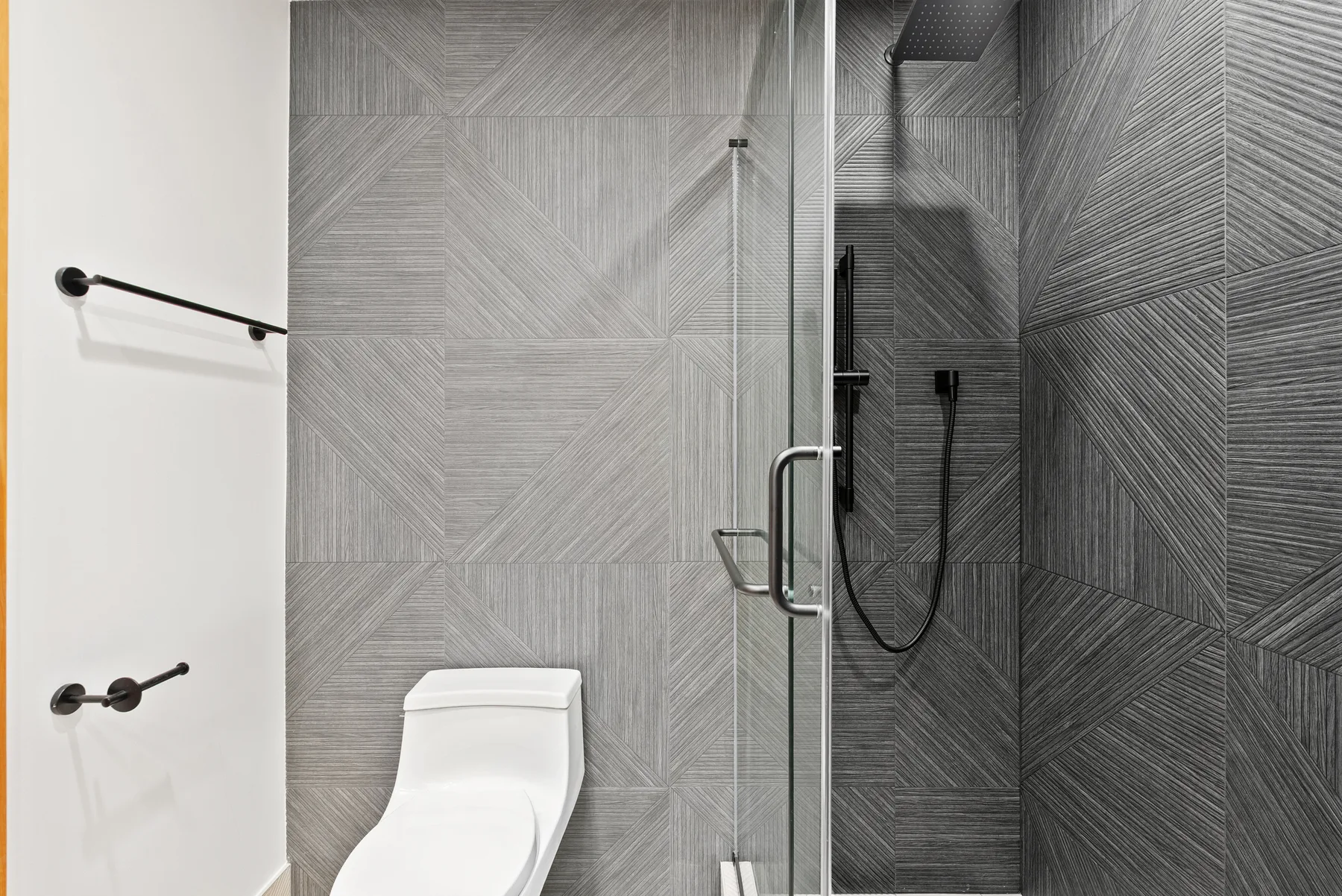 Charcoal tile shower with glass panel and new toilet, Redmond main bathroom