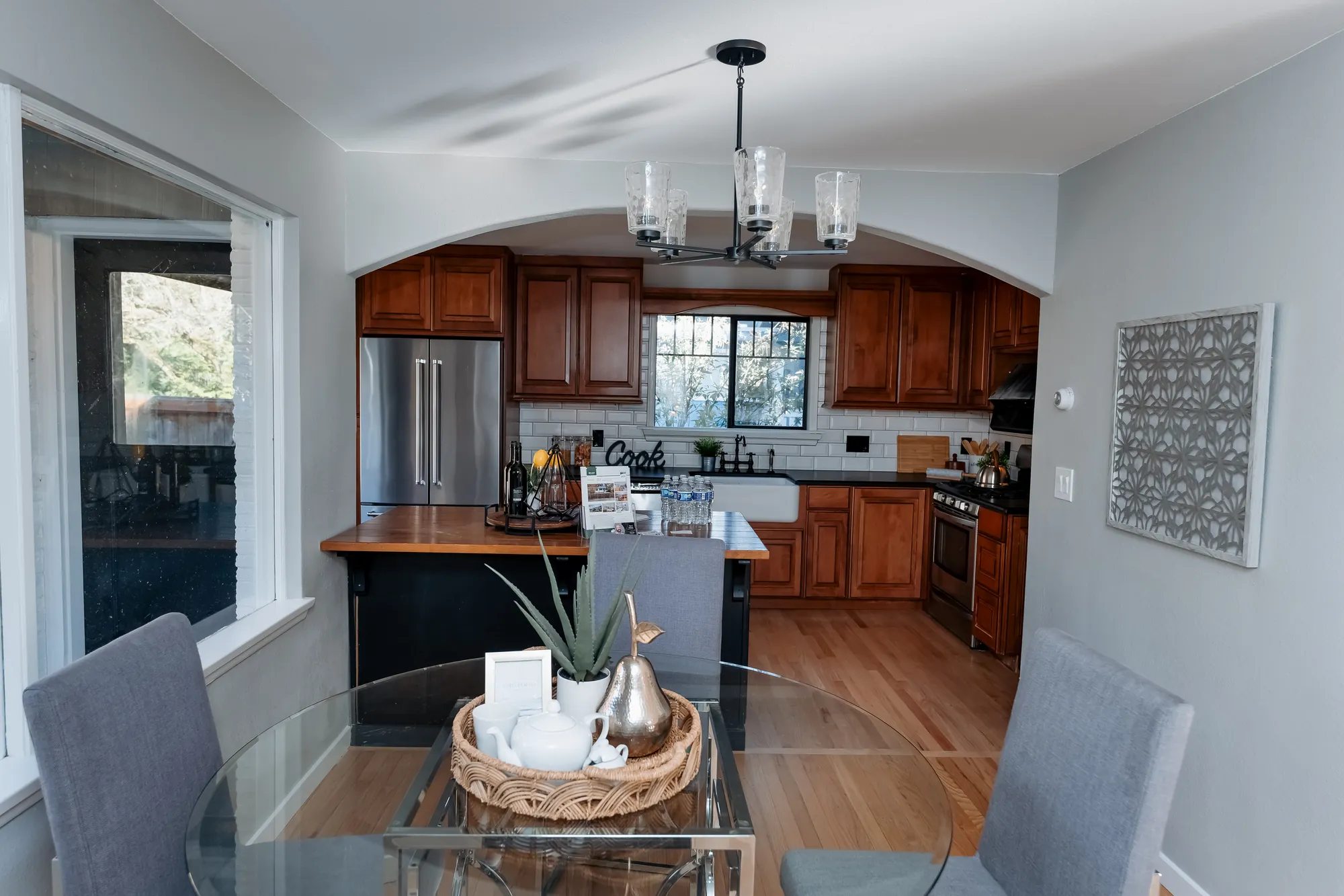 Kitchen and dining space with pendant lighting after restoration