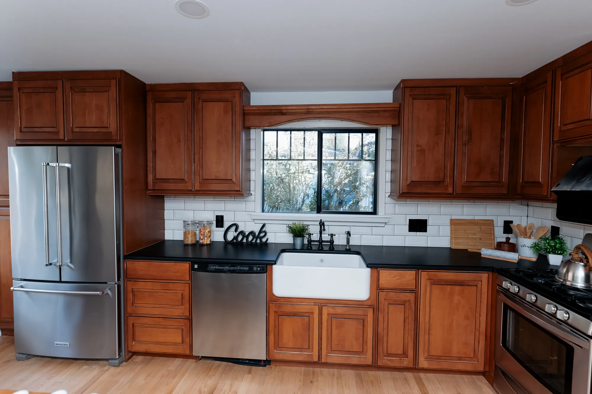 Refinished main-floor kitchen with farmhouse sink and stainless appliances