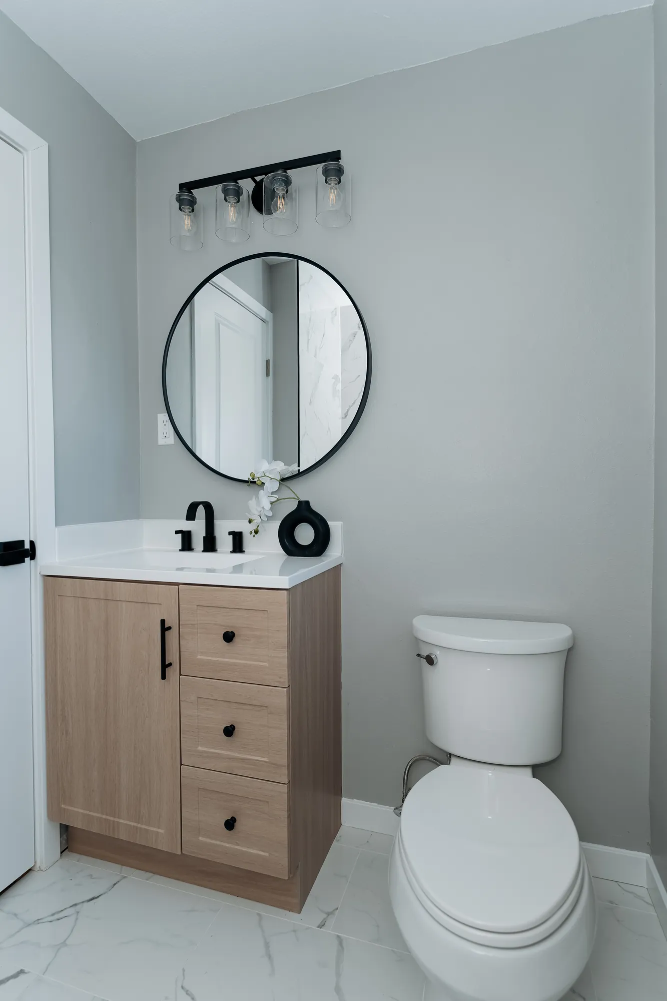 Brand-new upstairs bathroom with floating vanity and round mirror