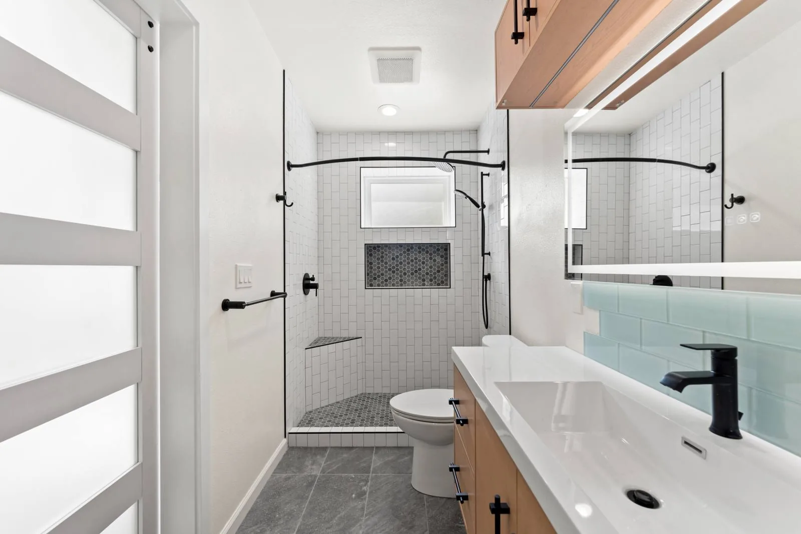 Guest bathroom vanity and walk-in shower in the View Ridge attached ADU, Seattle