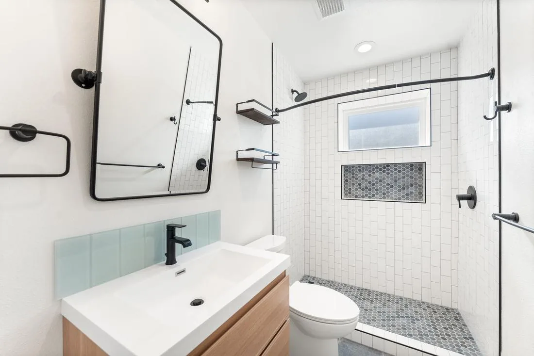 Second full bathroom with walk-in subway-tile shower and hex niche, Seattle ADU