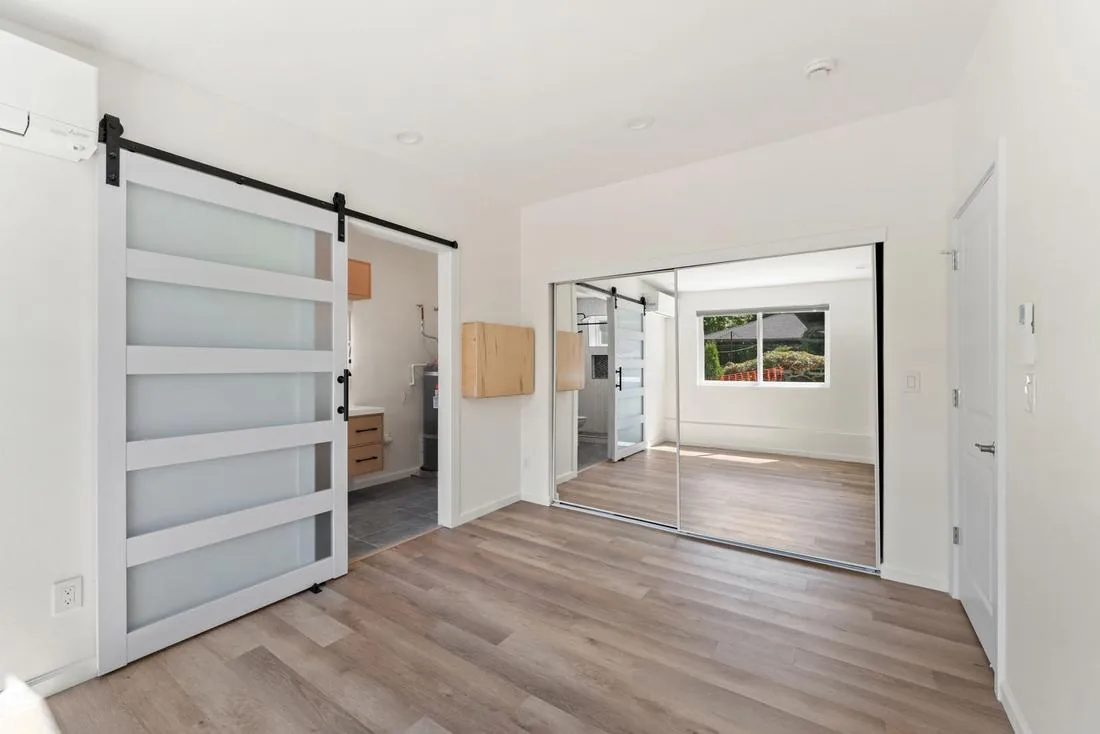 Primary bedroom with barn door in the View Ridge attached ADU, Seattle