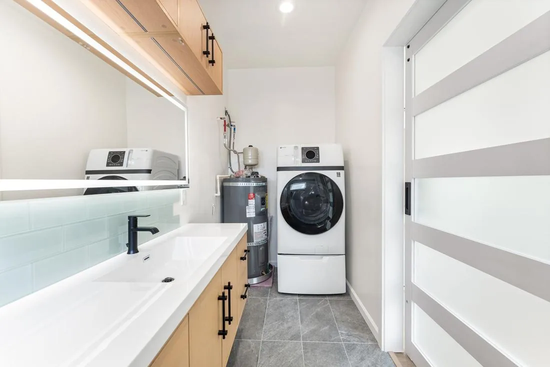 In-unit stacked washer and dryer in the ADU primary bathroom, Seattle